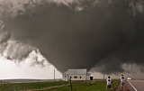 Storm chasers photograph tornado passing behind church - near Howes, South Dakota