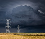 Power pylons in front of dark storm - Dickens, Texas