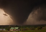 Tornado passing behind farmhouse - rural South Dakota